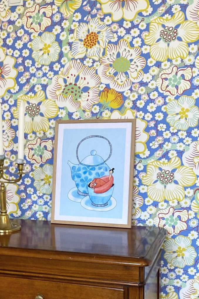 ROOIBOS kunstplakat i naturtræsramme på mørk kommode foran blomstret tapet